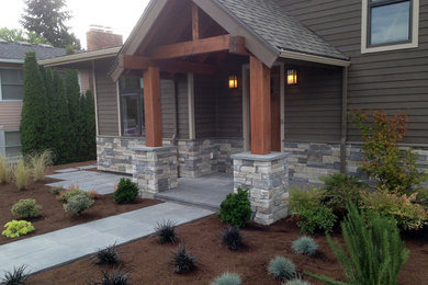Example of an arts and crafts stone exterior home design in Seattle