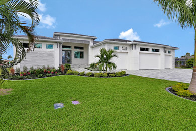 Inspiration for a large contemporary white one-story house exterior remodel in Other with a tile roof