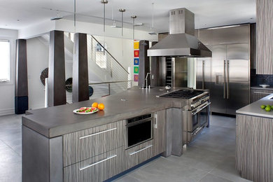 Eat-in kitchen - large modern l-shaped ceramic tile and gray floor eat-in kitchen idea in Salt Lake City with a single-bowl sink, flat-panel cabinets, dark wood cabinets, concrete countertops, blue backsplash, mosaic tile backsplash, stainless steel appliances and an island
