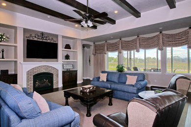 Living room - traditional open concept carpeted and beige floor living room idea in Denver with beige walls, a standard fireplace, a brick fireplace and a wall-mounted tv