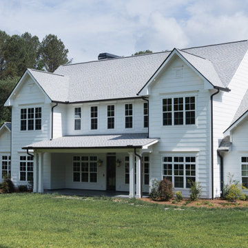 Timeless Modern Farmhouse Curb Appeal: White Siding & Expansive Front Porch