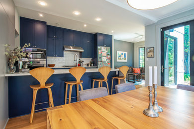 Classic kitchen/dining room in DC Metro with grey walls and light hardwood flooring.
