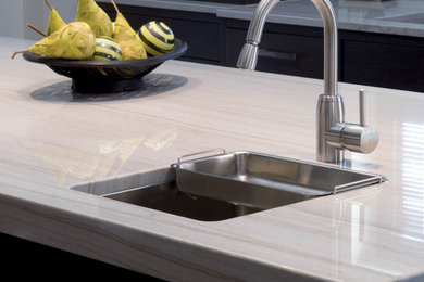 Example of a small minimalist kitchen design in Dallas with quartzite countertops, white backsplash, stone slab backsplash, an island and white countertops