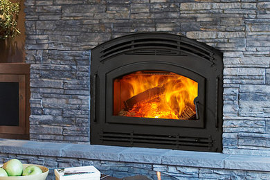 Photo of a traditional family room in Seattle with a standard fireplace, a stone fireplace surround and no tv.