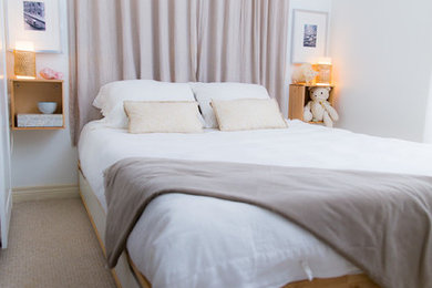 Small beach style master carpeted bedroom photo in Toronto with yellow walls