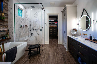 Example of a large transitional master multicolored tile and porcelain tile ceramic tile, brown floor, double-sink, exposed beam and brick wall bathroom design in Cleveland with recessed-panel cabinets, brown cabinets, a two-piece toilet, white walls, a drop-in sink, quartz countertops, a hinged shower door, white countertops and a built-in vanity