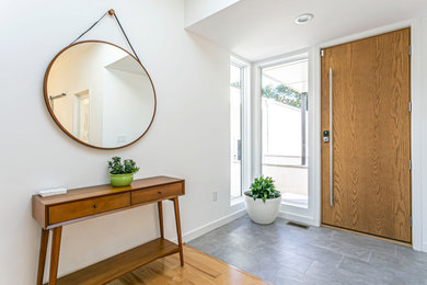 Example of a large trendy entryway design in Richmond with white walls and a medium wood front door