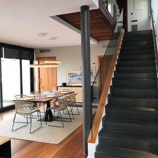 Photo of a contemporary straight glass railing staircase in Barcelona with slate treads and slate risers.