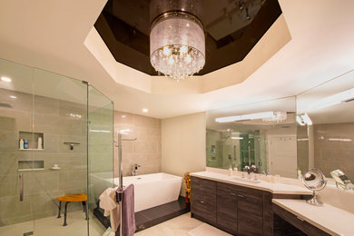Mid-sized trendy master gray tile and porcelain tile marble floor and beige floor corner shower photo in Miami with flat-panel cabinets, dark wood cabinets, beige walls, an undermount sink, quartz countertops and a hinged shower door