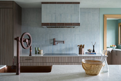 Example of a large minimalist light wood floor eat-in kitchen design in Portland with a farmhouse sink, flat-panel cabinets, blue cabinets, blue backsplash, ceramic backsplash, paneled appliances, an island and white countertops