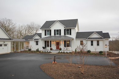 Example of a mid-sized cottage white two-story concrete fiberboard gable roof design in Richmond