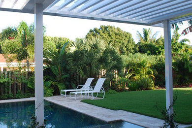 Inspiration for a modern backyard stone and custom-shaped pool remodel in Miami