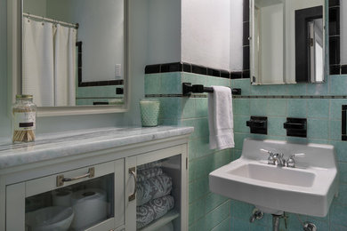Bathroom - mid-sized modern bathroom idea in Tampa with glass-front cabinets, white cabinets and marble countertops