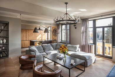 Photo of a large industrial formal open concept living room in London with grey walls, medium hardwood floors, a standard fireplace, a stone fireplace surround and a freestanding tv.