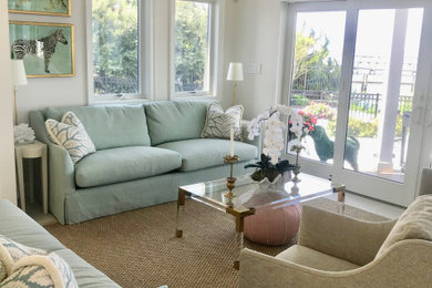 Beach style light wood floor living room photo in New York with beige walls