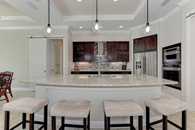 Kitchen - mid-sized contemporary ceramic tile and beige floor kitchen idea in Portland with a double-bowl sink, dark wood cabinets, granite countertops, beige backsplash, ceramic backsplash, stainless steel appliances and an island