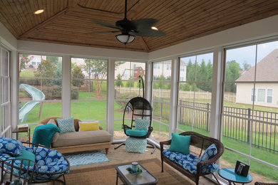 Photo of a mid-sized traditional sunroom in Charlotte with brick floors, no fireplace and a standard ceiling.