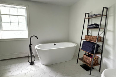 Bathroom - large transitional master gray tile ceramic tile, multicolored floor and double-sink bathroom idea in Boston with flat-panel cabinets, brown cabinets, gray walls, a drop-in sink, quartz countertops, a hinged shower door, white countertops and a freestanding vanity
