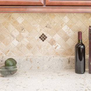 This is an example of a mid-sized traditional l-shaped kitchen pantry in Orlando with an undermount sink, raised-panel cabinets, medium wood cabinets, quartz benchtops, multi-coloured splashback, travertine splashback and no island.