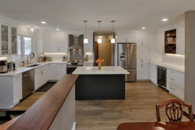 Transitional kitchen photo in Edmonton with shaker cabinets and an island