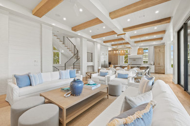 Family room - coastal light wood floor and shiplap wall family room idea in Miami with white walls and a wall-mounted tv