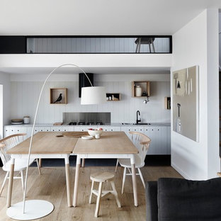 Design ideas for a scandinavian open plan dining in Melbourne with white walls, light hardwood floors and beige floor.