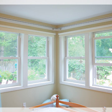 Black out drapery paired with roller shades.