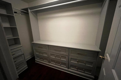 Walk-in closet - mid-sized contemporary women's dark wood floor and brown floor walk-in closet idea in Philadelphia with shaker cabinets and gray cabinets