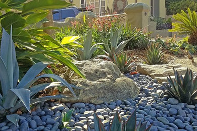 This is an example of a large traditional front yard full sun xeriscape in San Francisco with concrete pavers.