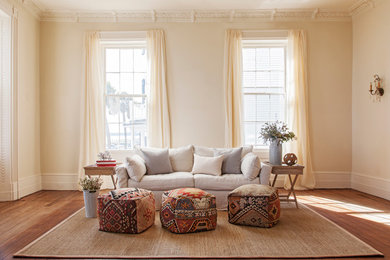 Inspiration for a mid-sized timeless formal and enclosed medium tone wood floor living room remodel in Charleston with beige walls and no fireplace