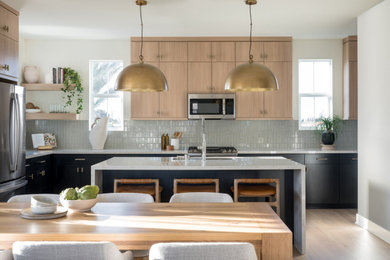 Inspiration for a large contemporary l-shaped light wood floor and beige floor eat-in kitchen remodel in Orange County with an undermount sink, flat-panel cabinets, brown cabinets, quartz countertops, ceramic backsplash, stainless steel appliances, an island, white countertops and gray backsplash