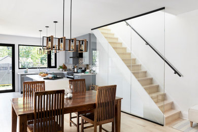 Inspiration for a mid-sized contemporary l-shaped light wood floor and yellow floor eat-in kitchen remodel in Toronto with a single-bowl sink, shaker cabinets, gray cabinets, quartz countertops, gray backsplash, ceramic backsplash, stainless steel appliances, an island and white countertops