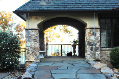 Inspiration for a large transitional beige two-story brick exterior home remodel in Charleston with a shingle roof