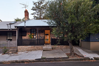 Photo of a small contemporary one-storey brick black exterior in Sydney.