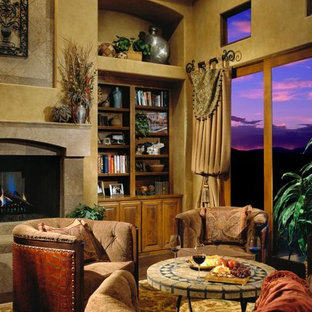 Design ideas for a mediterranean formal living room in Los Angeles with yellow walls, dark hardwood flooring, a hanging fireplace and a plastered fireplace surround.