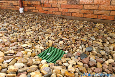 Surface drain and river rock installation