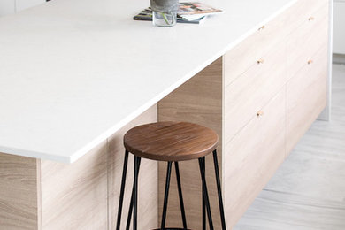 Photo of a contemporary u-shaped kitchen in Perth with a double-bowl sink, light wood cabinets, glass sheet splashback, stainless steel appliances, ceramic floors and with island.