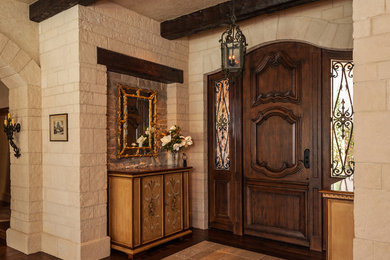 This is an example of a large arts and crafts foyer in Salt Lake City with beige walls, dark hardwood floors, a single front door and a dark wood front door.