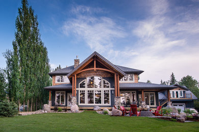 Mountain style wood exterior home photo in Other