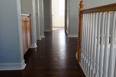 Hallway - mid-sized medium tone wood floor hallway idea in San Diego with white walls