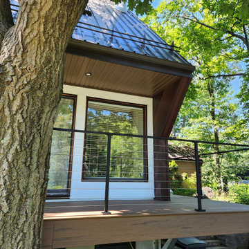 Deck with black metal post cable railing in Quebec, Canada