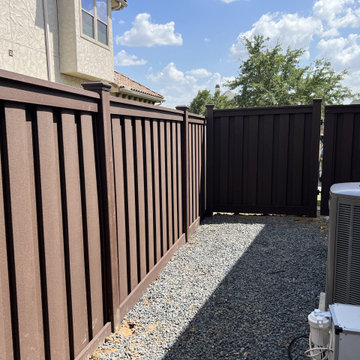 Dark Brown Composite Trex Fence and Black Iron Fence