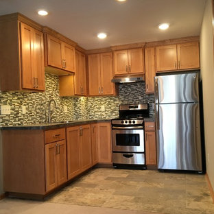 This is an example of a small modern basement in Minneapolis with beige walls and limestone flooring.