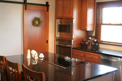 Kitchen - mid-sized transitional l-shaped medium tone wood floor kitchen idea in Other with an undermount sink, recessed-panel cabinets, medium tone wood cabinets, granite countertops, white backsplash, ceramic backsplash, stainless steel appliances and an island