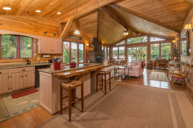 Mountain style living room photo in New York with a stone fireplace