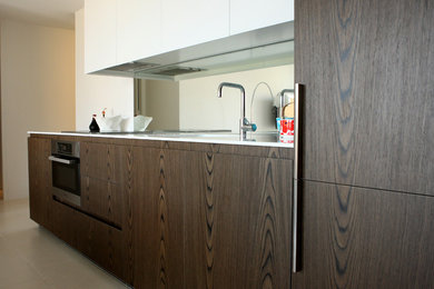 This is an example of a small modern single-wall open plan kitchen in Sydney.