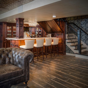 Inspiration for a medium sized eclectic look-out basement in Detroit with multi-coloured walls, porcelain flooring, a brick fireplace surround and black floors.