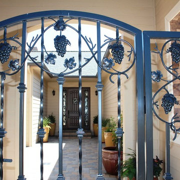 Vineyard themed wrought iron gate to portico and tuscan courtyard