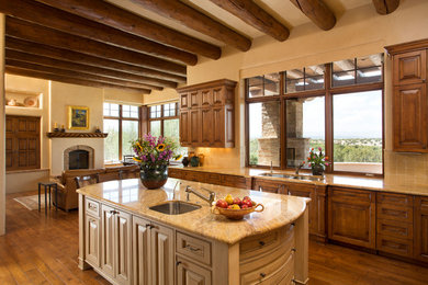 Open concept kitchen - mid-sized mediterranean l-shaped dark wood floor open concept kitchen idea in Albuquerque with a double-bowl sink, raised-panel cabinets, beige backsplash, an island, medium tone wood cabinets, granite countertops and ceramic backsplash