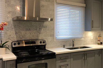 Example of a mid-sized trendy galley ceramic tile and gray floor eat-in kitchen design in Toronto with an undermount sink, gray cabinets, marble countertops, gray backsplash, marble backsplash, stainless steel appliances and white countertops
